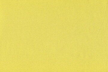 Texture of natural yellow cotton fabric. Simple yellow background of soft pure knitted fabric.