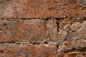 Red brick stone wall with uneven and crushed stones, stones background with space for text
