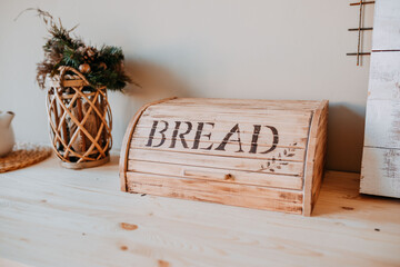 Christmas decorations. Bascet with fir branches and breadbox on the wooden table. Festive table decorations. - obrazy, fototapety, plakaty