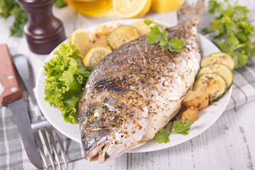 close up on grilled fish and lettuce
