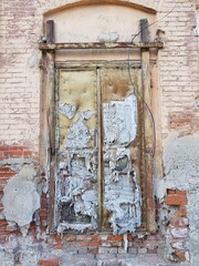Destroyed wooden door in a stone house