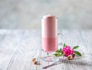 Pink Latte Tea. Pink hibiscus latte. Fashionable romantic drink. Dry flowers of roses. Pink...