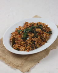 Pampis Tuna is an indonesian traditional food from minahasa made from shredded smoked skipjack tuna with spices. On blurry texture.