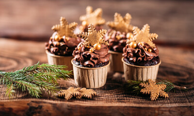 Chocolate cupcakes with star shaped cookies on a wooden background. Christmas mood. Sweets for any occasion