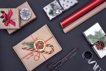 New year gift wrapping layout, boxes, craft paper, ribbons, scissors on the table, top view, zero waste Christmas concept