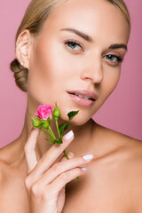 Fototapeta premium beautiful blonde woman with perfect skin and rose flower isolated on pink