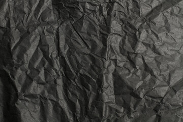 Fondo de textura de papel negro oscuro arrugado irregular. Vista de cerca