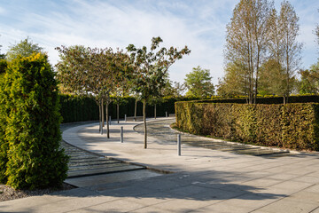 City Park Krasnodar. Artificial rushing river with granite banks. Evergreen hedge encloses recreation area. Public landscape 