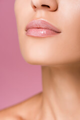 Fototapeta na wymiar cropped view of beautiful woman with shiny lips isolated on pink