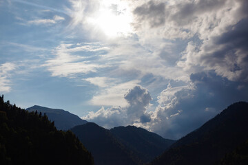 Beautiful mountain green peaks against cloudy sky, used as background or texture