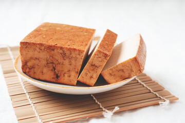 Brick of organic somoked tofu cheese