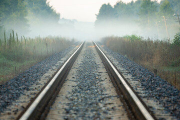 Fototapeta premium On the tracks, an approaching train to cross
