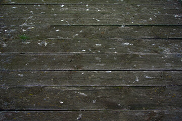 An old and worn wooden walkway surface 