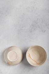 Two white clay bowls on a light background