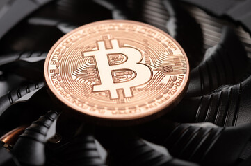 Bitcoin coin on a graphic card. Mining cryptocurrency