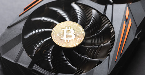 Bitcoin coin on a graphic card. Mining cryptocurrency