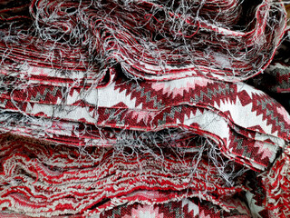 A pile of trimmed fabric. Texture from yarn and fabric. Textile manufacture