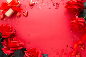 Valentine's day mock up, red roses, gift box and hearts on red background with copy space.