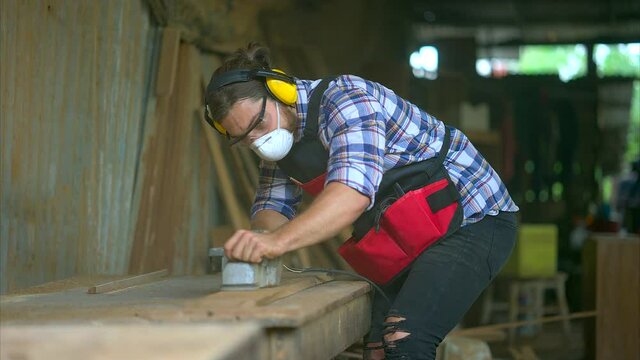 Carpenter man doing woodwork in workshop