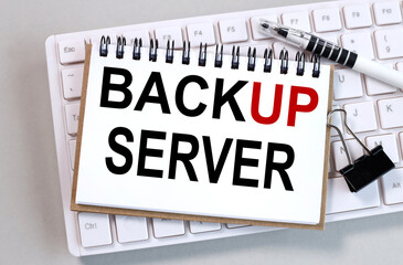 business, technology, internet BACKUP SERVER, Text on white paper on a gray background on a computer keyboard