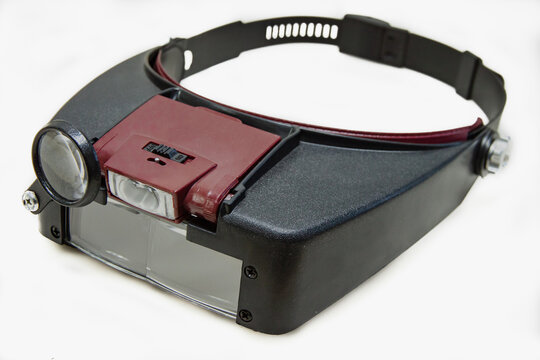 Glasses-magnifier with led illumination with a head mount. Isolated