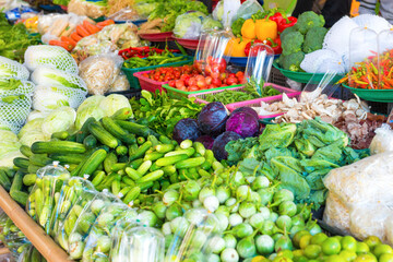 Food market with stall full of asian fruits and vegetables. Thailand fresh groceries