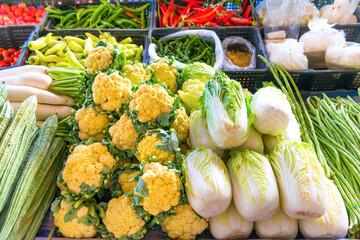 Food market with stall full green cabbages and vegetables. Thailand fresh groceries