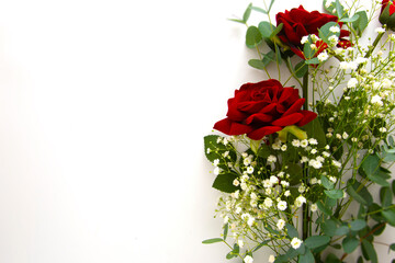 Flower composition from red rose and gypsophila flower eucalyptus branches and leaves isolated on white background.