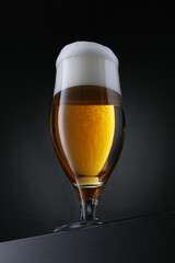 Glass of beer on black background