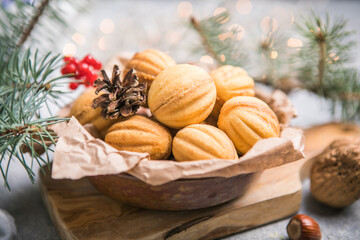 Chriatmas food. Shortbread russian walnut shaped cookies Oreshki with caramel.Close-up