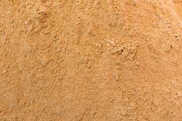 River sand, flat surface of yellow quartz wet sand in a quarry.