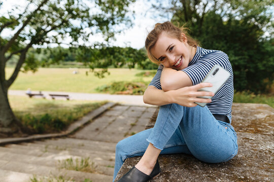 Friendly young woman relaxing in a rural park