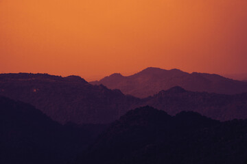 Silhouette of mountains, golden sky. Retro filter effects