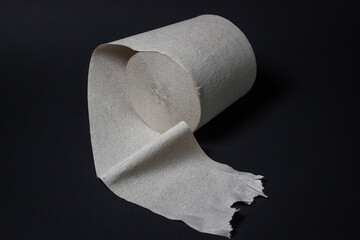 Toilet paper on a black background. Personal hygiene. Paper product.