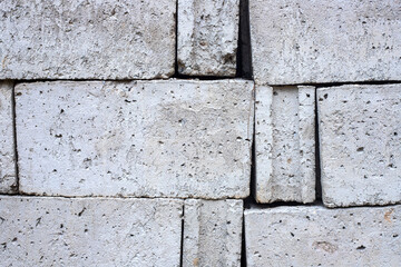 White concrete bricks closeup photo texture. Concrete block surface. Rough grey stone brick. Masonry wall made of big block. Rustic stone texture. Industrial stone brickwork.