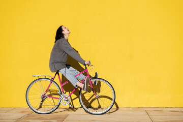 young girl laughs as she plays on her retro bike