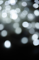 Abstract pattern of white bokeh lights on a dark background