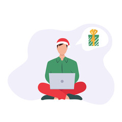 Man sitting on the floor choosing Christmas gifts with laptop 