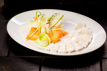 chicken fillet with vegetables on a white plate