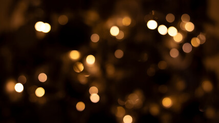Beautiful festive bokeh on a black background golden circles, light night bokeh effect, deflated....