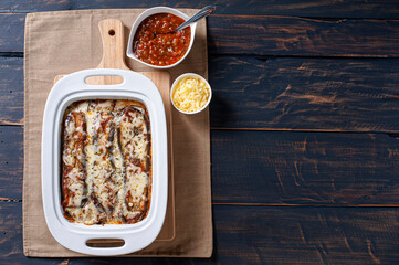 .Eggplant parmigiana with cheese and tomato sauce. Top view. Copy space