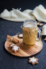 Pumpkin spiced latte or coffee in a cup on a turquoise vintage background. Autumn, fall, or winter hot drink. Cozy breakfast or snack.