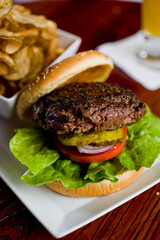 Hamburger. Grade A grass fed angus beef, ground into hamburger meat. Hamburger patties seasoned w/ salt & pepper & flame grilled topped w/ cheddar cheese. O toasted bun w/ lettuce tomato onion Cheese
