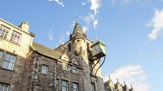 Time lapse of clock Canongate Toll Booth Clock of Edinburgh from royal mile during a sunny cloudy day