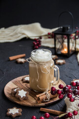 Pumpkin spiced latte or coffee in a cup on a turquoise vintage background. Autumn, fall, or winter hot drink. Cozy breakfast or snack.