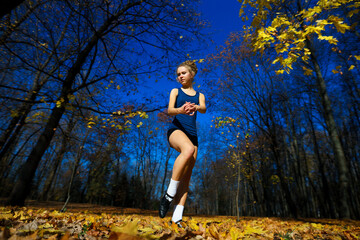 Healthy young woman warming up stretching her arms and looking away in the road outdoor.