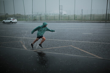 man runs in the rain