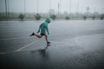 man runs in the rain