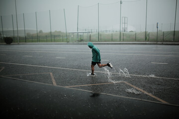 man runs in the rain