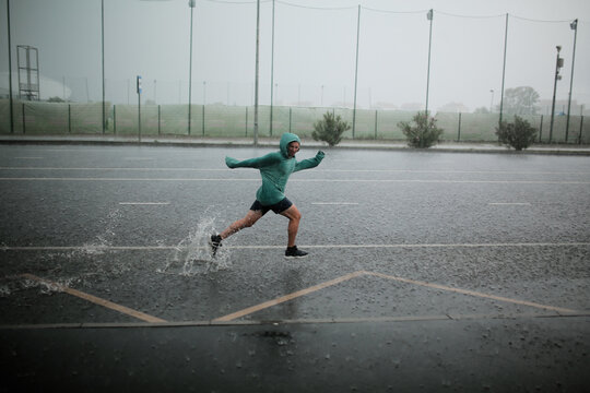 man runs in the rain